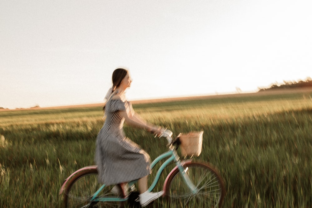a person riding a bicycle in a field
