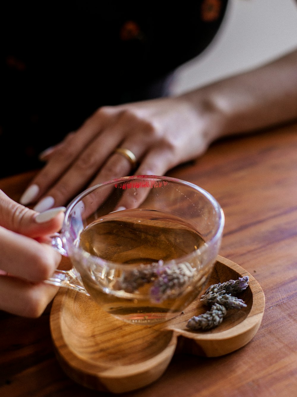 a person pouring a drink into a glass