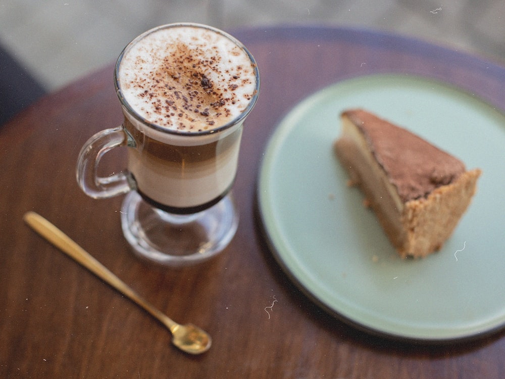 a cup of coffee and a slice of bread on a plate