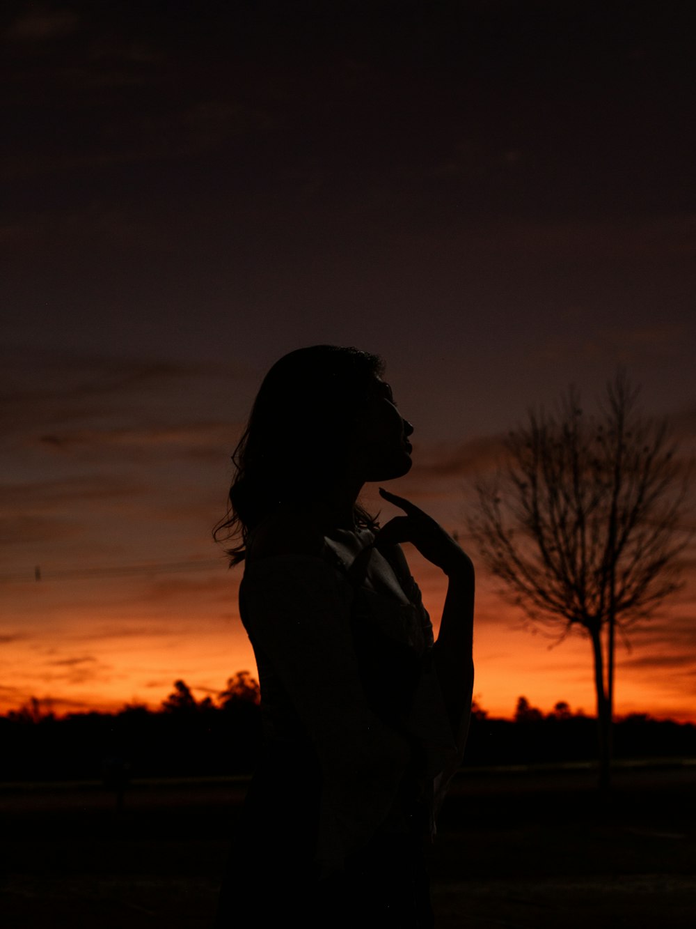 a person standing in front of a sunset