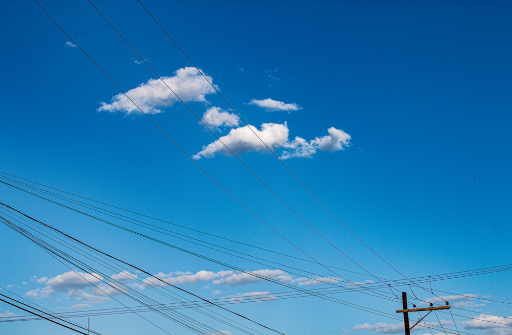 power lines with blue sky and clouds