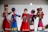 Five decorative dolls are dressed in traditional, colorful costumes showcasing intricate embroidery and accessories. Each doll's attire reflects a different style rich in cultural design, featuring vibrant colors and detailed ornamentation. The dolls are arranged in a display, emphasizing the artistic craftsmanship.