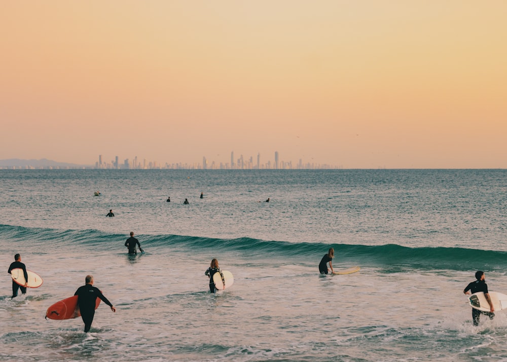 a group of surfers in the ocean