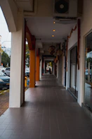 a sidewalk with a building on the side