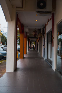 a sidewalk with a building on the side