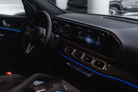 A sleek car dashboard showcasing modern electronic upgrades with glowing displays.