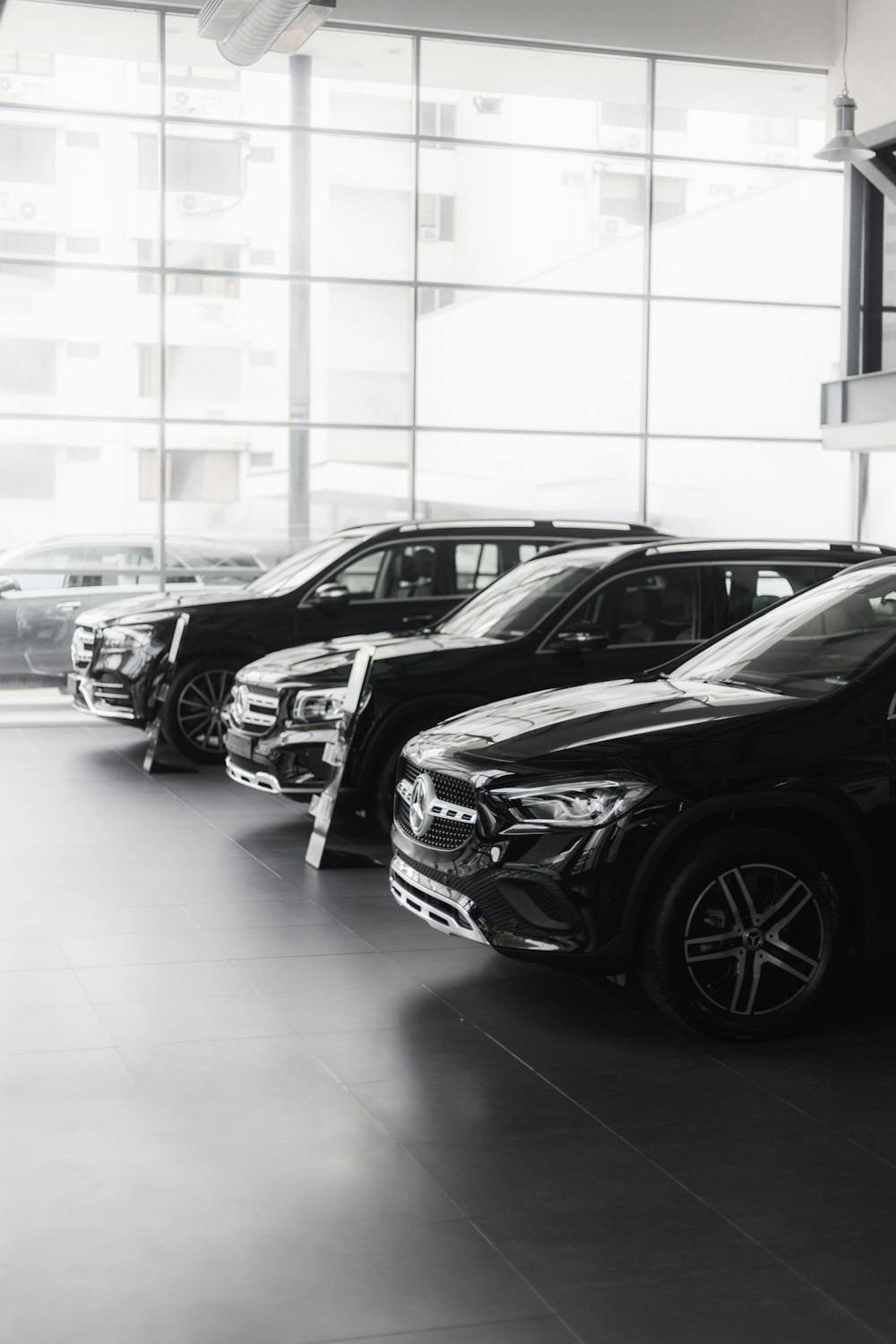 a group of cars parked in a large room