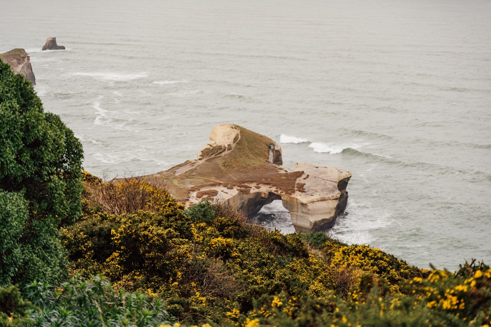 a rocky cliff next to a body of water