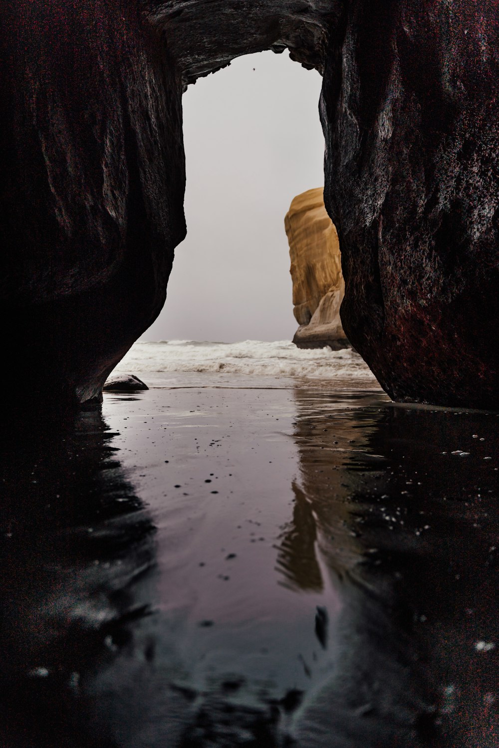 a view of the water through a rock formation