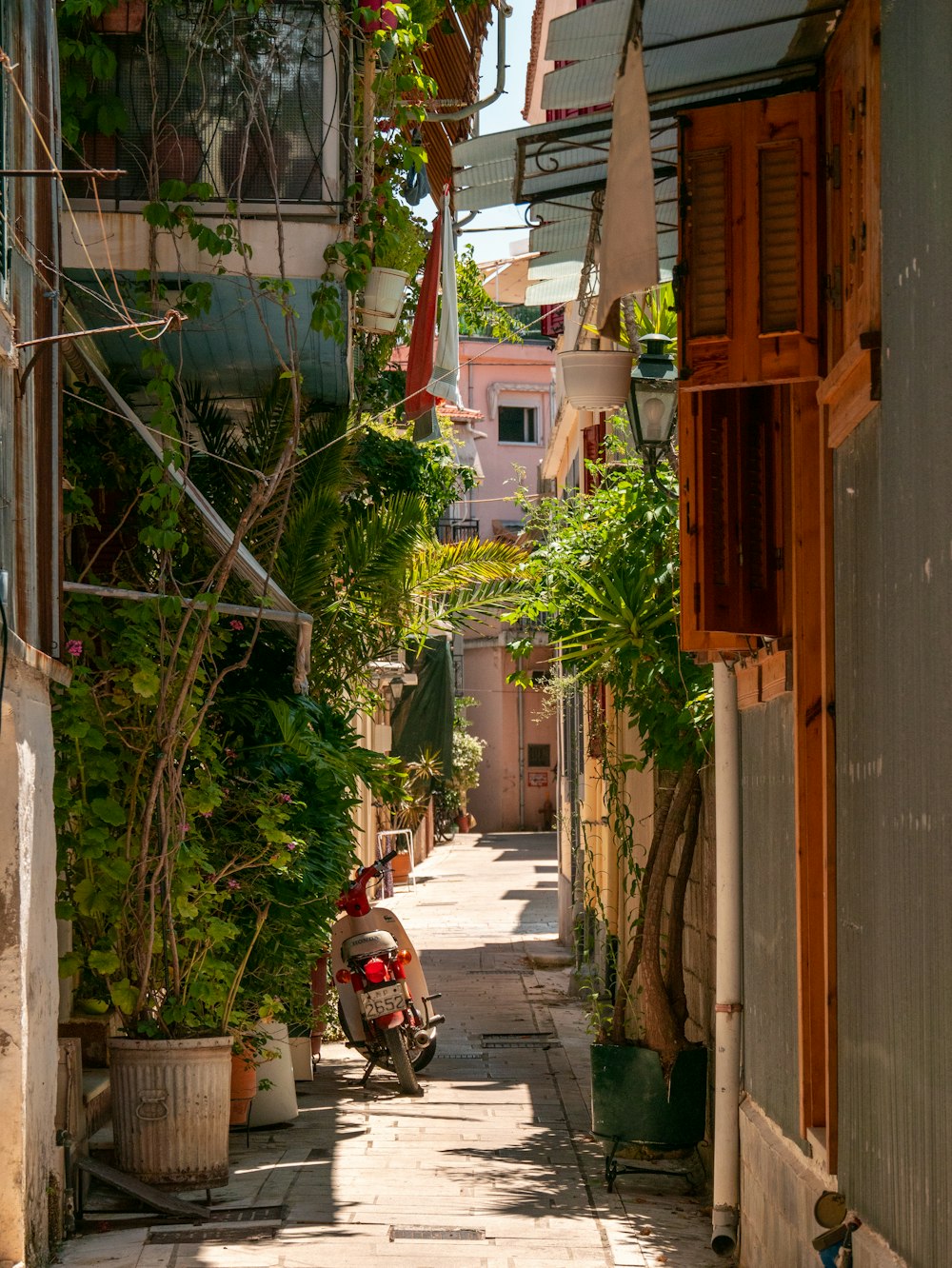 a scooter parked on a narrow street