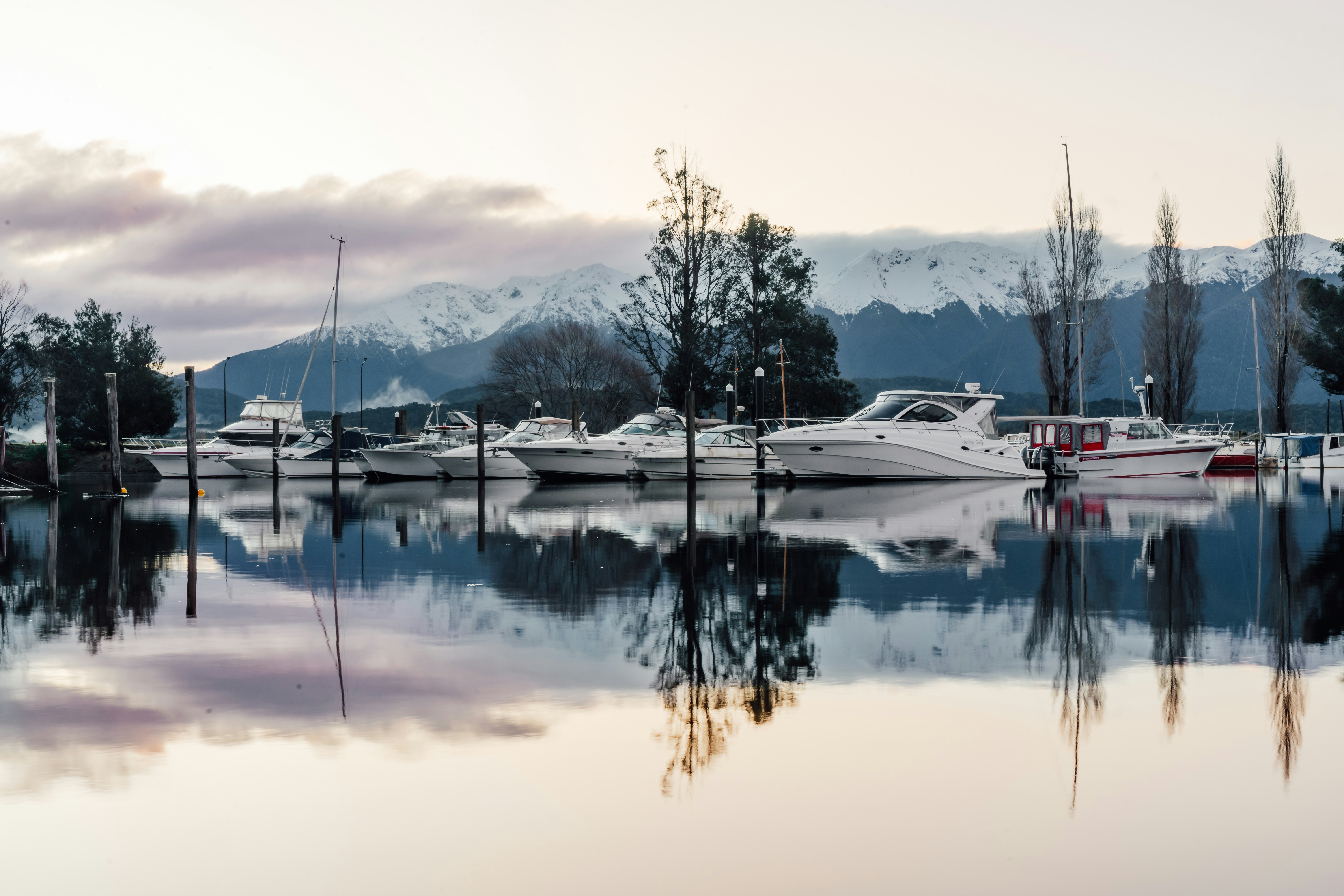 A group of boats sit in a harbor photo – Free Lake te anau Image on ...