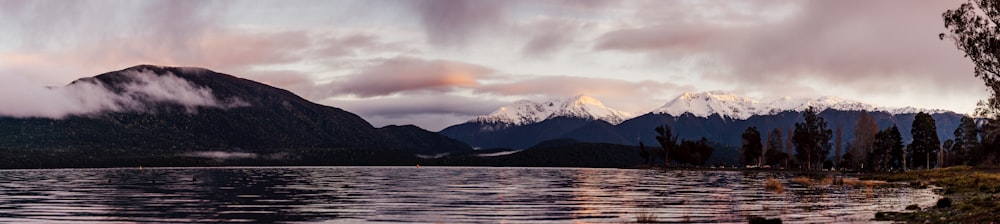 a lake with mountains in the background