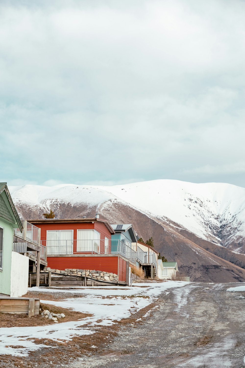 a red building with a snowy mountain in the background