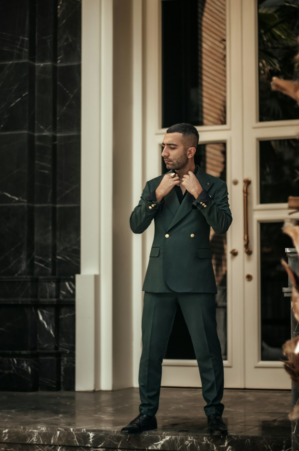 a person in a suit smoking a cigarette