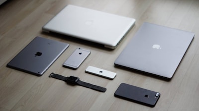 a group of cell phones and laptops on a table