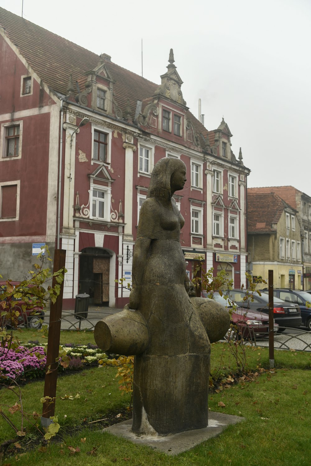 a statue of a person in front of a building