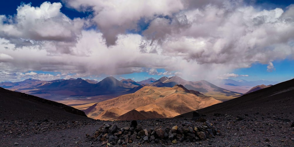 a rocky landscape with mountains in the background