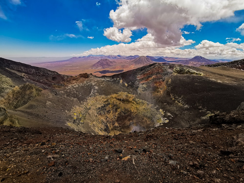 a landscape with hills and a blue sky