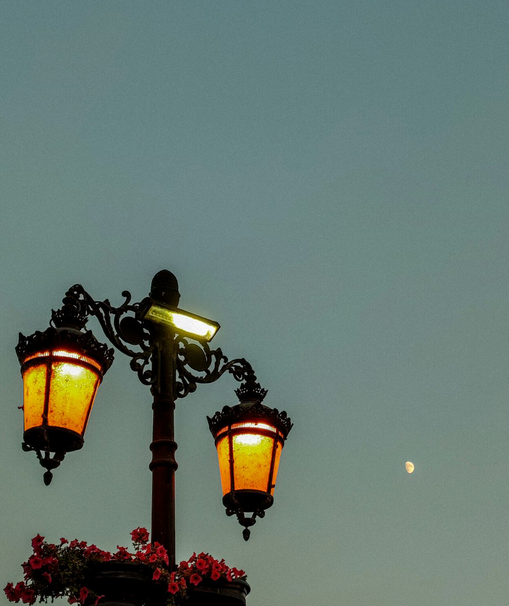 a light post with a moon in the background