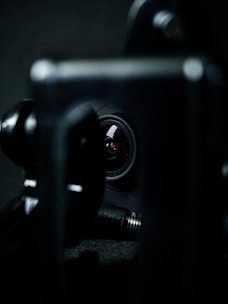 A close-up of a camera lens reflecting a family moment in soft focus.