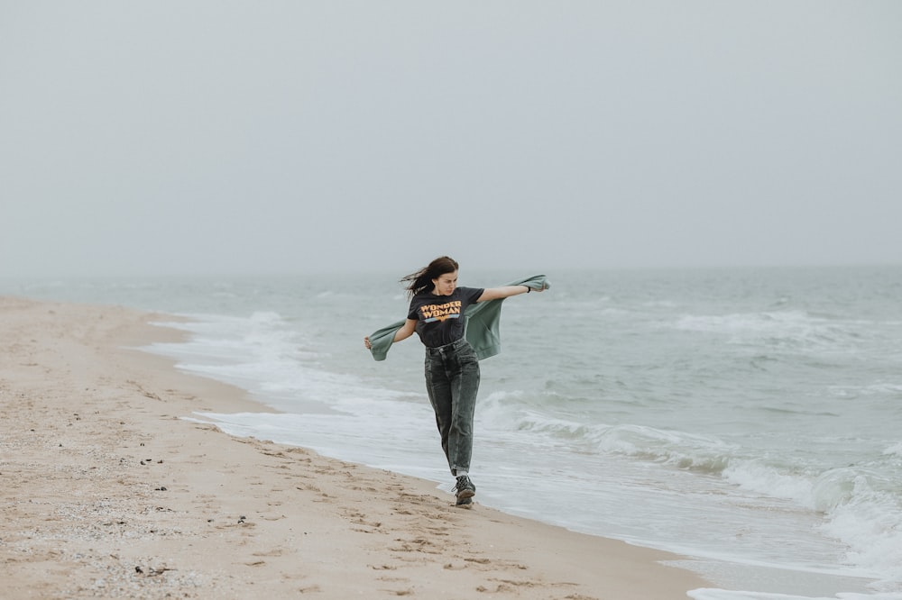 a man playing frisbee on the beach