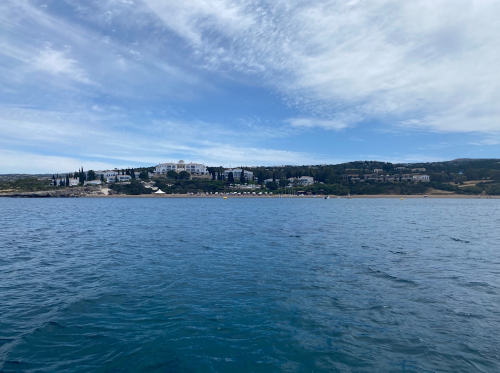 a body of water with buildings in the background