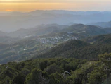 A peaceful countryside vista with rolling hills and soft, glowing skies.