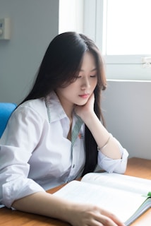 a young girl sitting at a desk