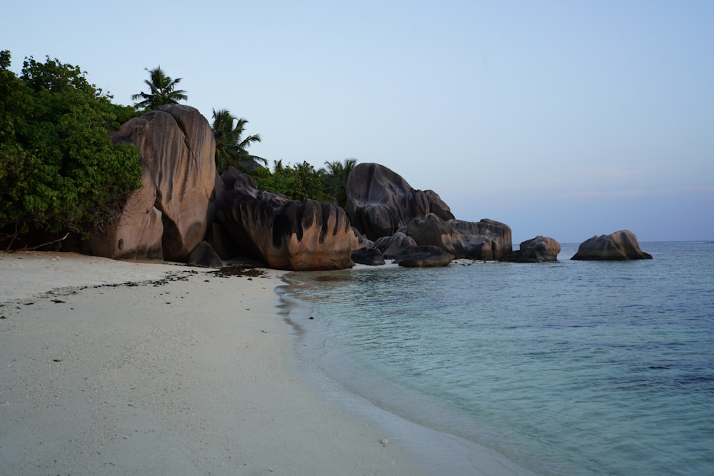 a group of large rocks on a beach