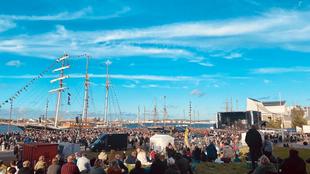 a crowd of people in front of a stage with a large crowd