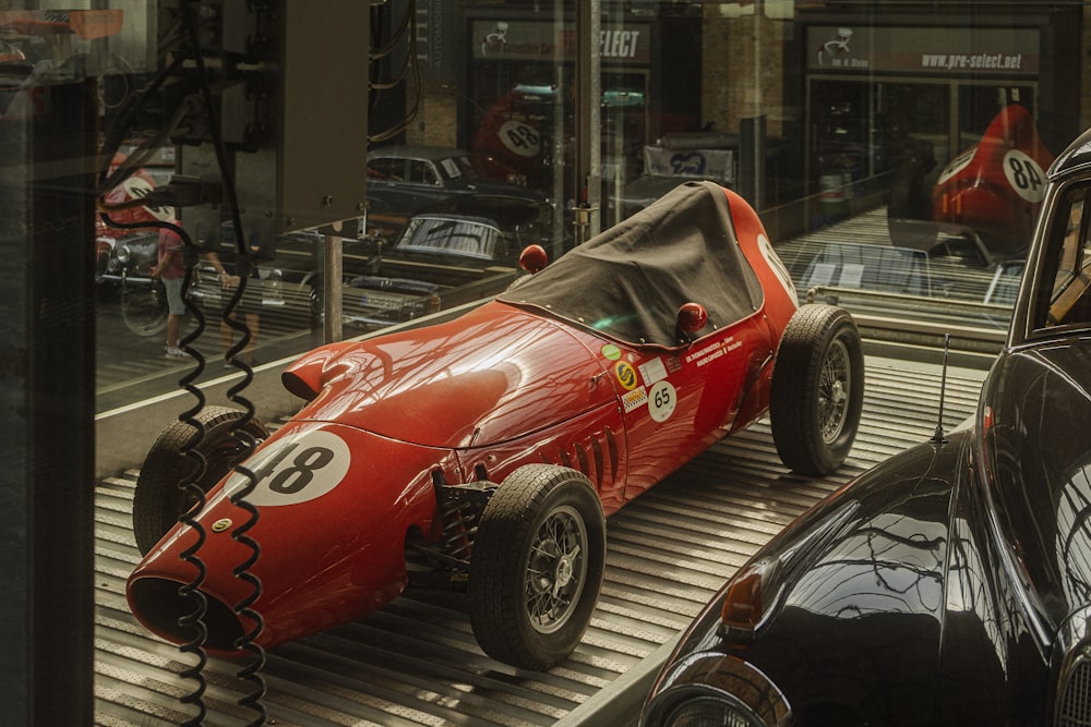 a red car parked in a showroom