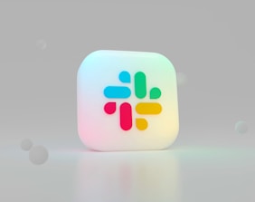 a small white cup with a pink and blue design on it