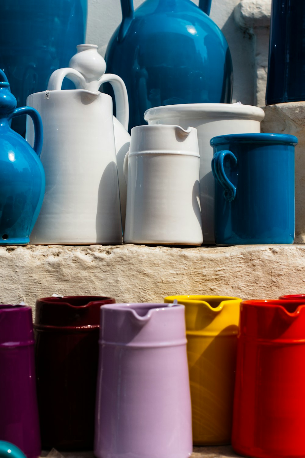 a group of vases and cups