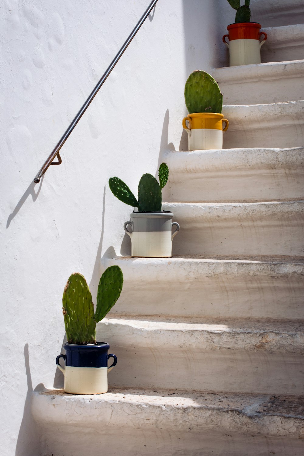 a set of tea cups and teapots on a staircase