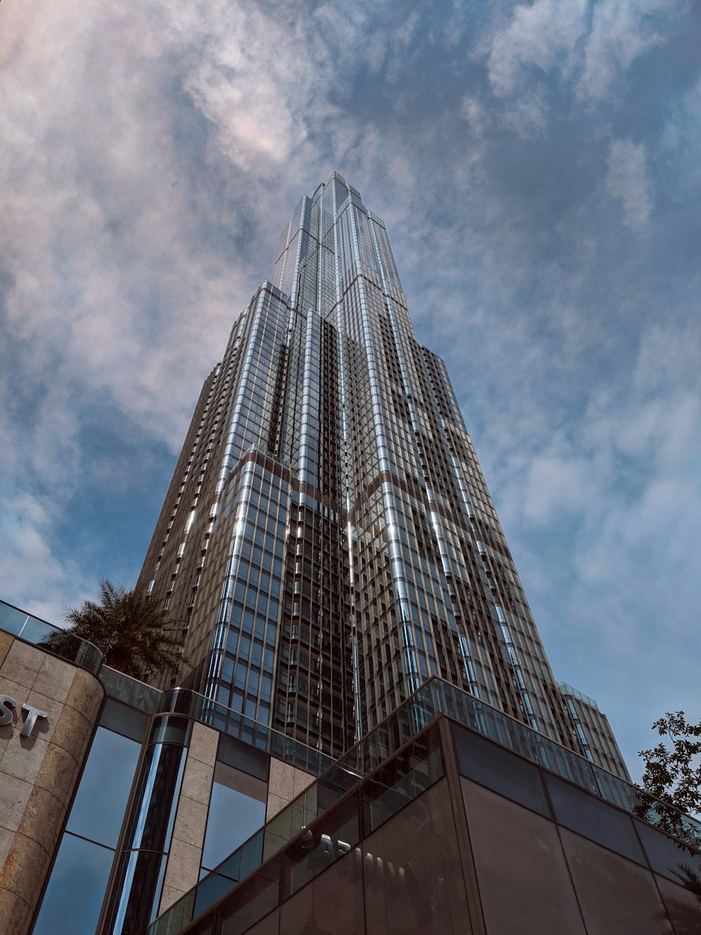 a tall building with a cloudy sky