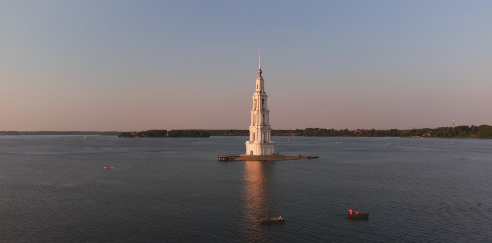 a large tower in the middle of a body of water