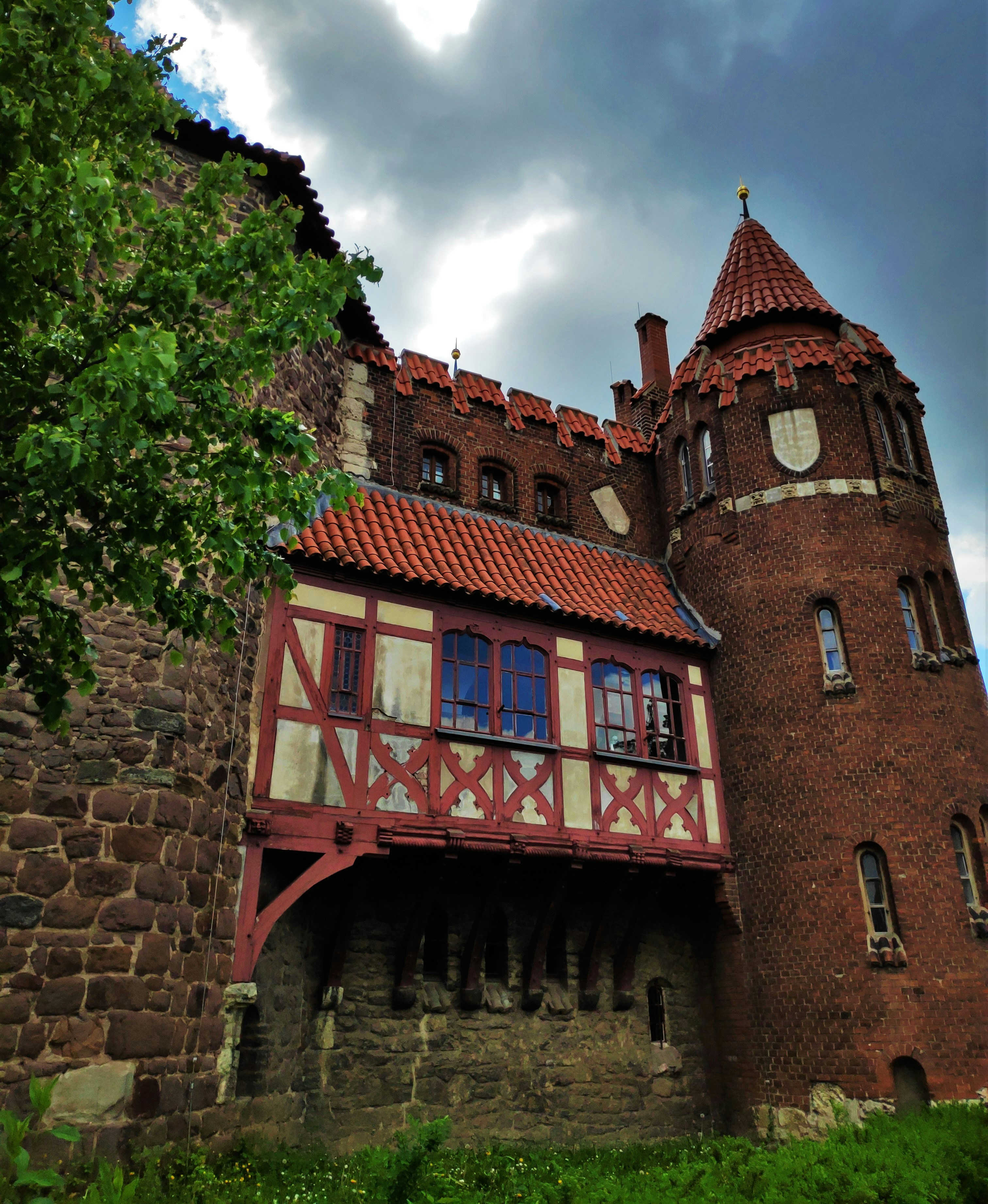 a large brick building with a red roof and a red roof