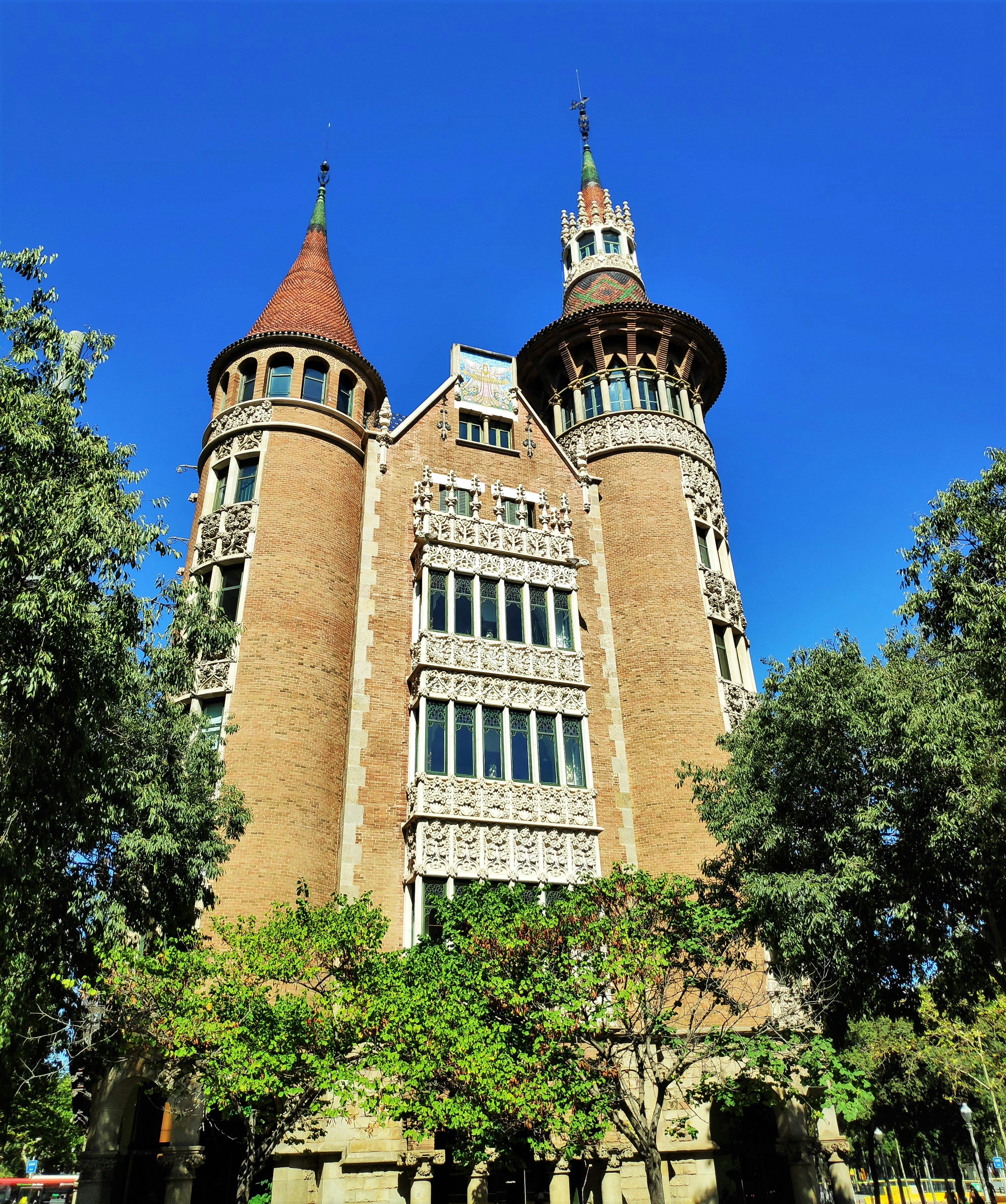 a large brick building with trees in front of it