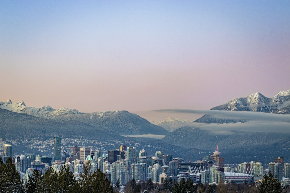 a city with snow covered mountains