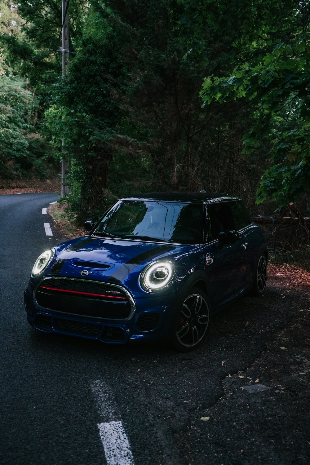 a blue car parked on a road