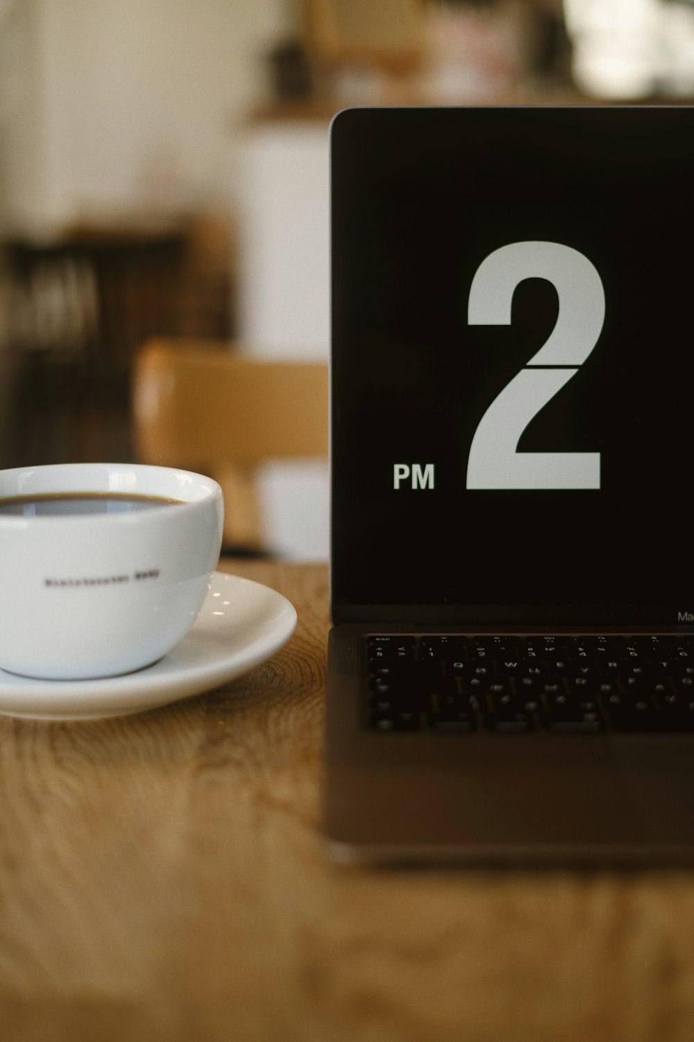 a laptop with a cup of coffee