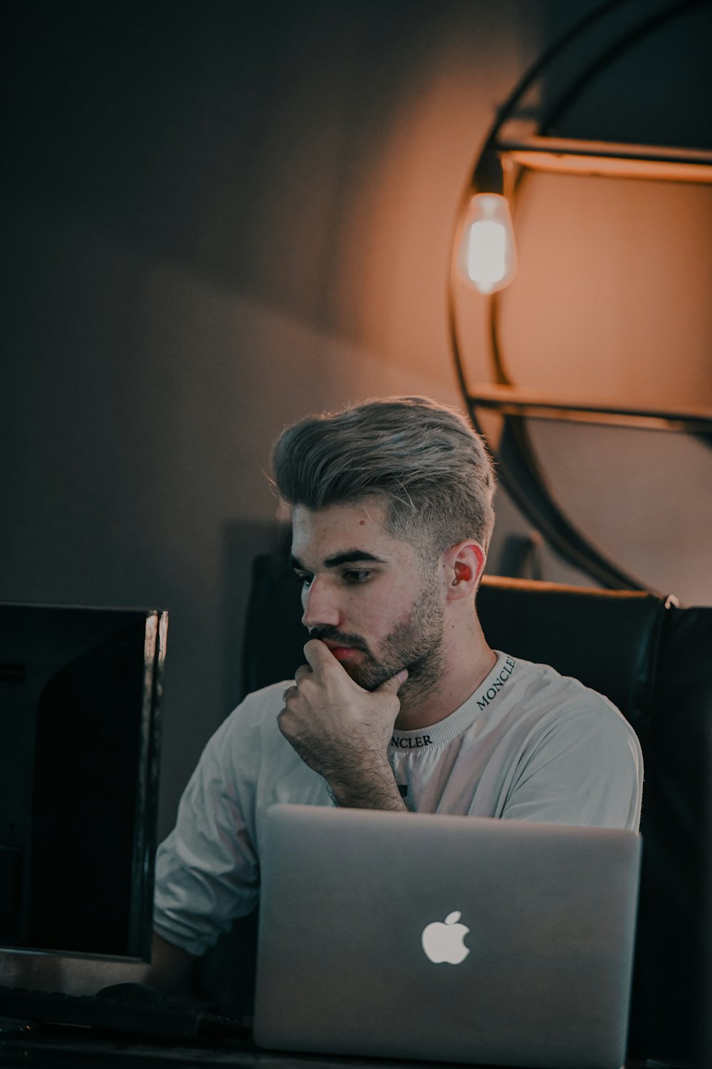 a man with a beard looking at a laptop