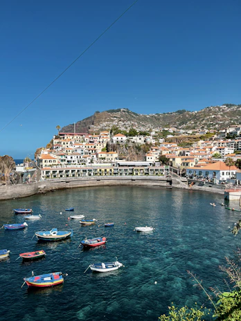 A charming seaside village in Crete with colorful fishing boats bobbing gently in the harbor.
