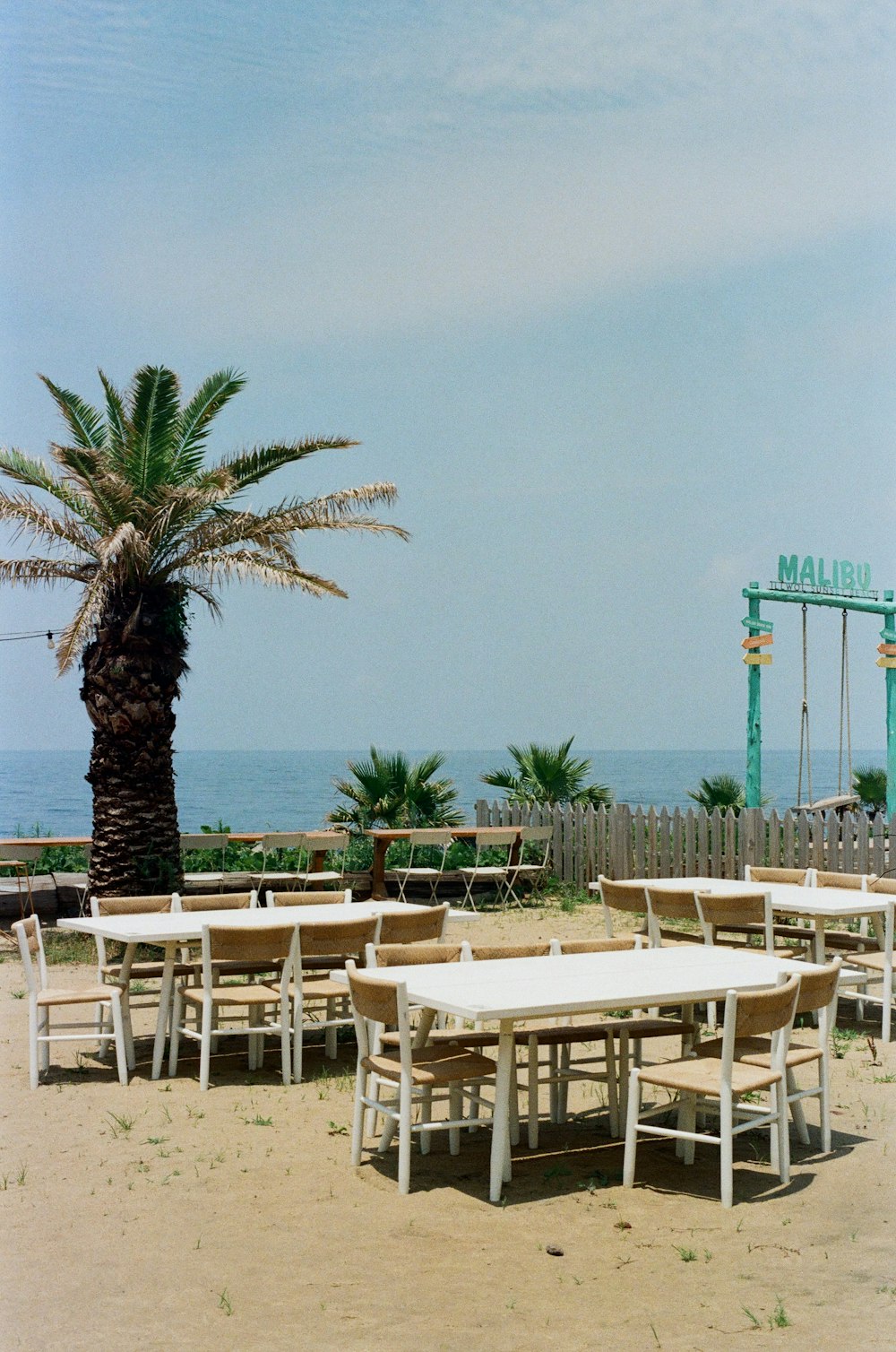 a beach with tables and chairs