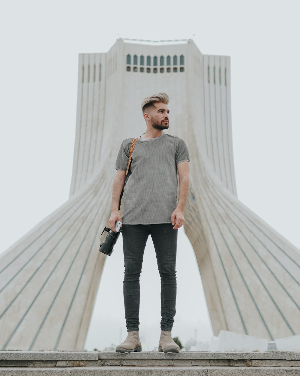 a man standing in front of a white building