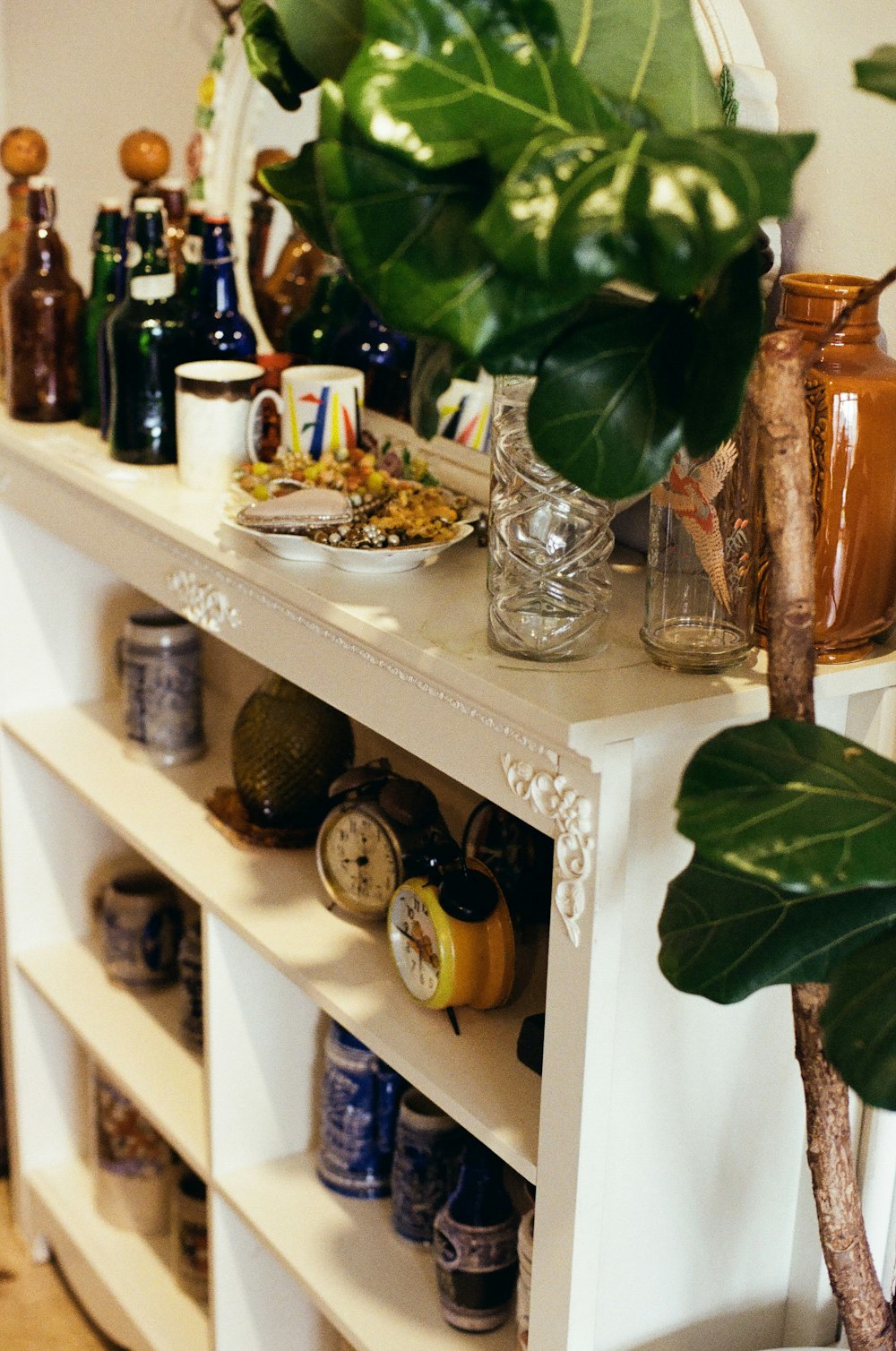 a shelf with bottles and glasses on it