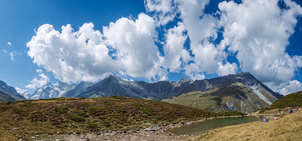 a river running through a valley with mountains in the background