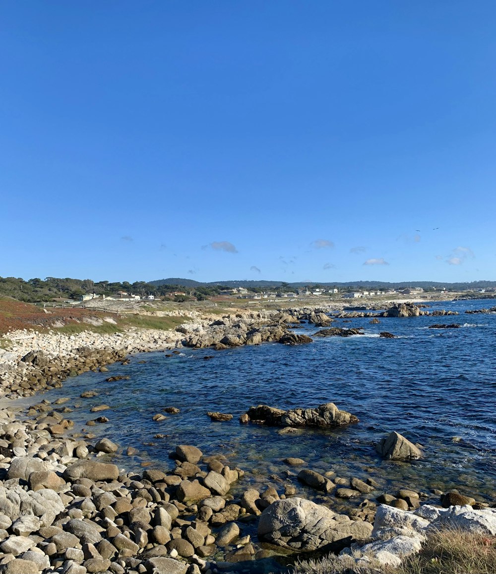 a rocky beach with blue water