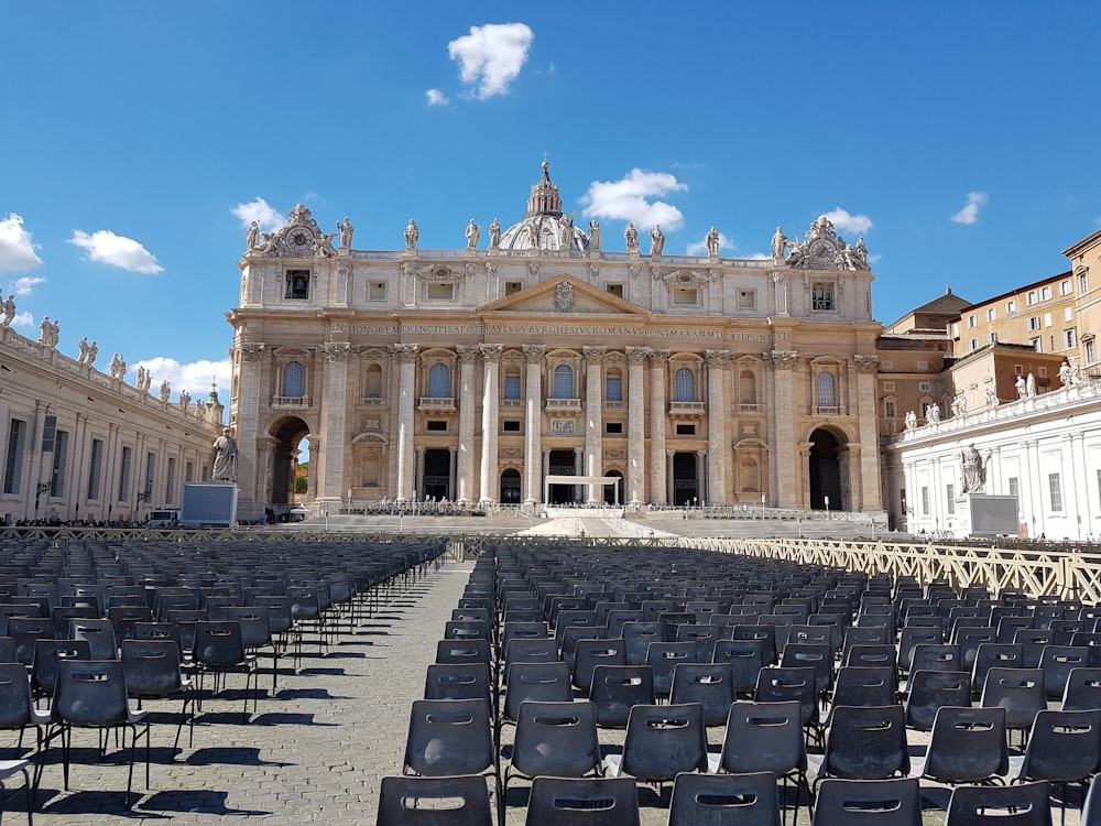 a large building with many chairs in front of it