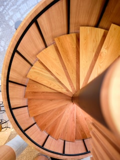 Close-up of a handcrafted wooden staircase with elegant curves and smooth finish.
